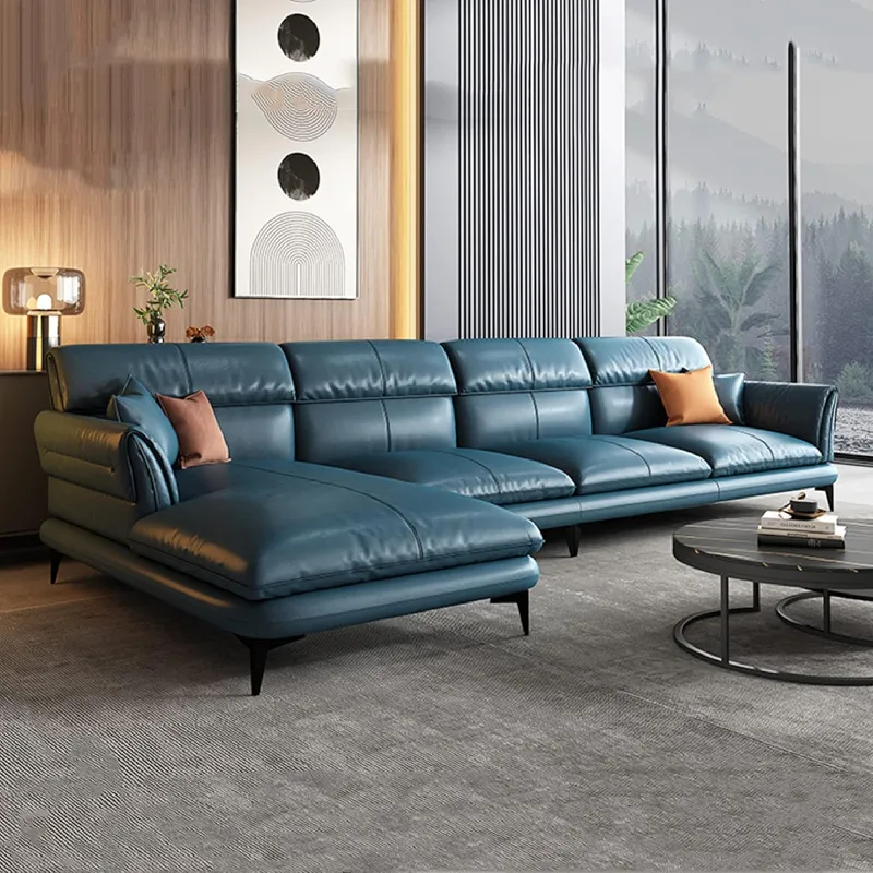 A teal leather upholstery sectional sofa with a chaise lounge.