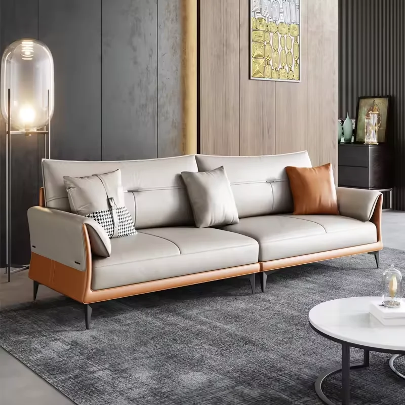 A two-tone gray and tan leather upholstery sofa with pillows.