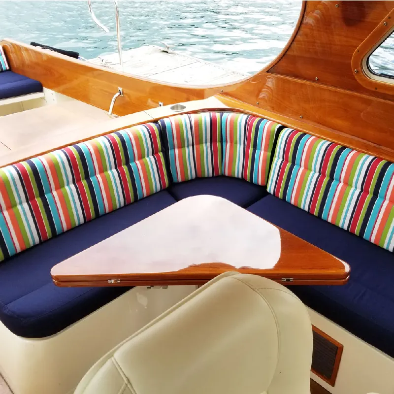 Boat seating with colorful striped Sunbrella upholstery.