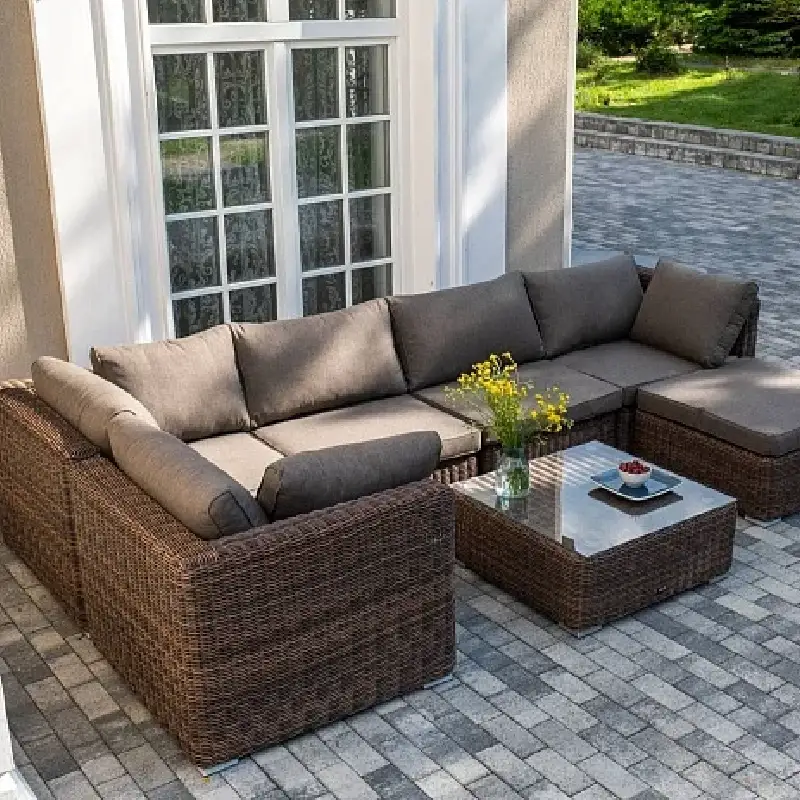 Brown woven patio furniture with Sunbrella upholstery.