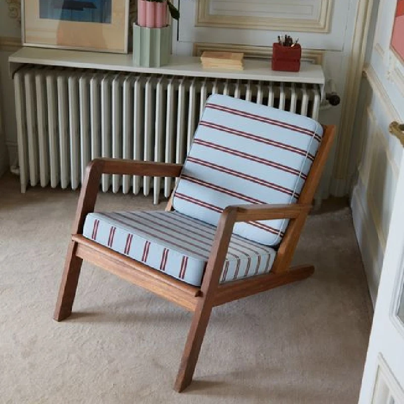 Chair with striped blue Sunbrella upholstery.