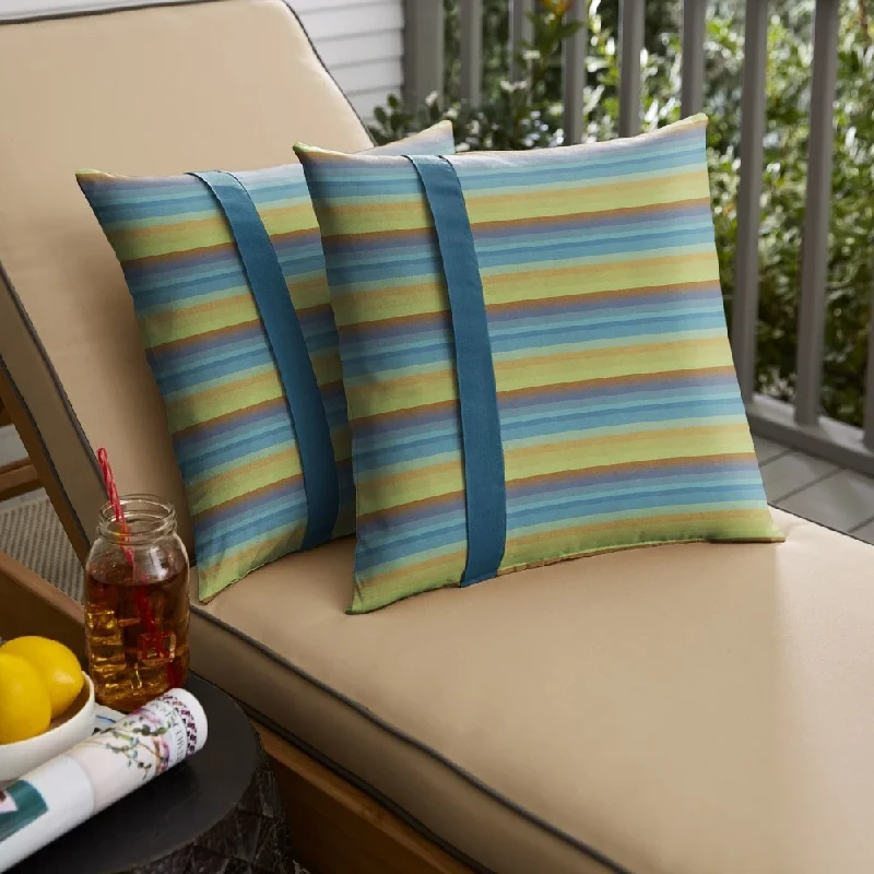 Colorful striped pillows on a neutral-colored chaise cushion.