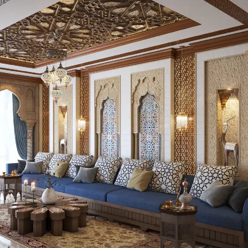 Moroccan majlis featuring a low blue sofa with patterned pillows, ornate geometric wall panels