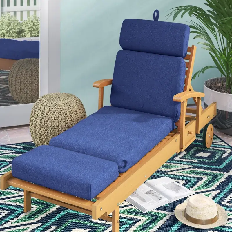 New Blue padded chaise cushion on a wooden chair.
