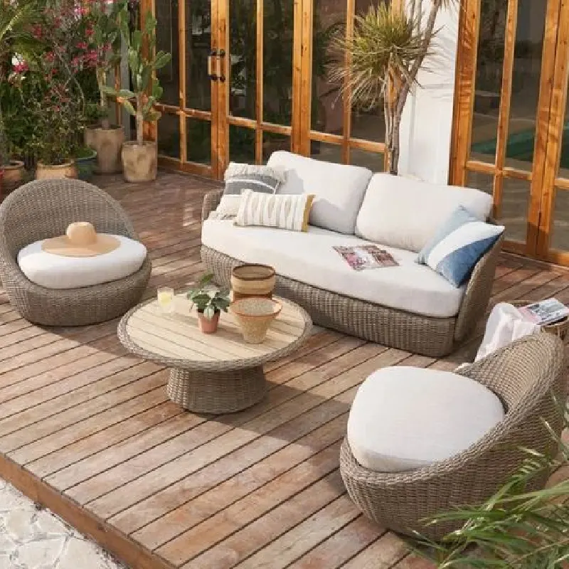 patio sofa and chairs with light-colored outdoor upholstery on a wooden deck