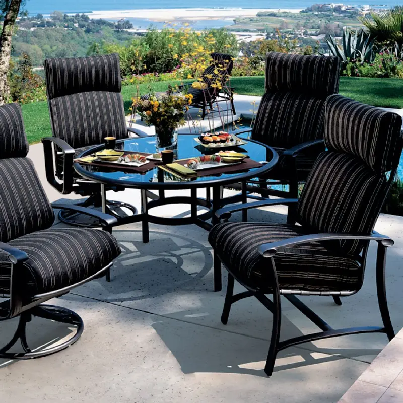 glass table and chairs featuring striped outdoor upholstery