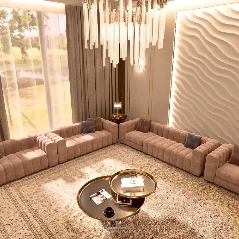 ladies majlis with two plush pink sofas, a large glass chandelier, and gold-toned coffee tables