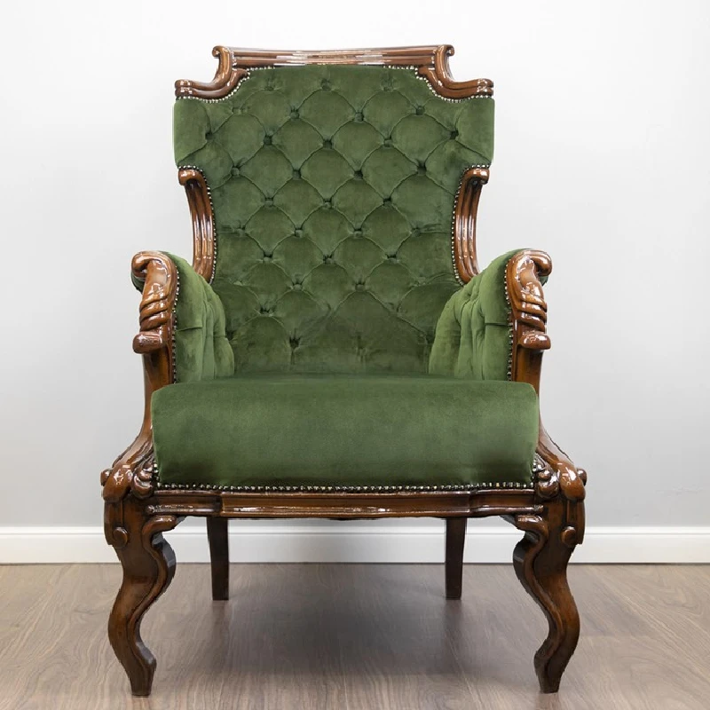 newly reupholstered antique armchair with green velvet fabric