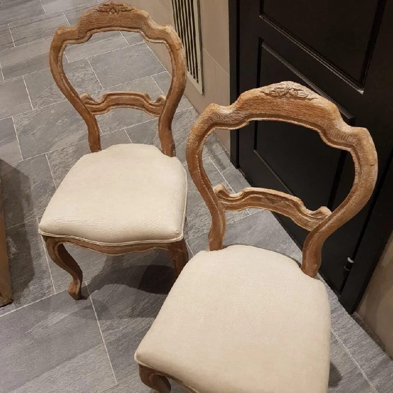 off-white upholstery are shown side-by-side, awaiting repair