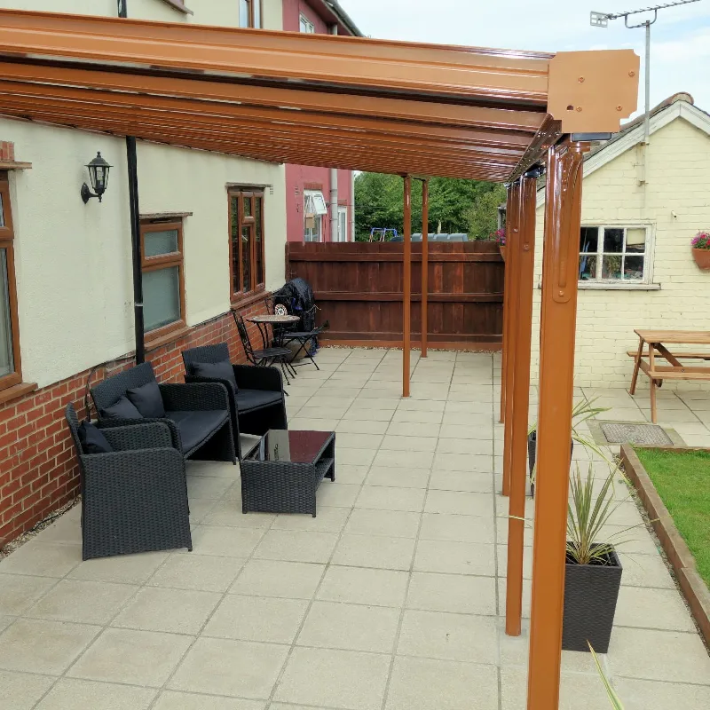 patio with a brown, metal custom pergola that has adjustable slats