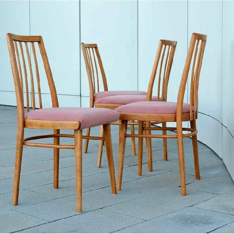 set of four mid-century modern wooden chairs with pink upholstered seats