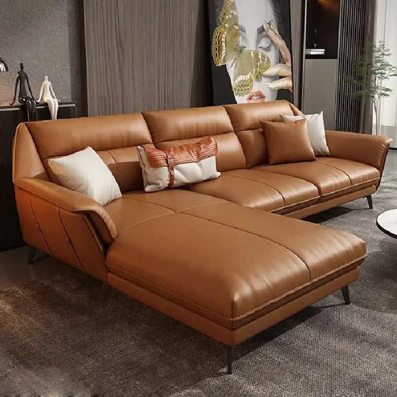 tan leather sectional sofa with a chaise lounge and throw pillows