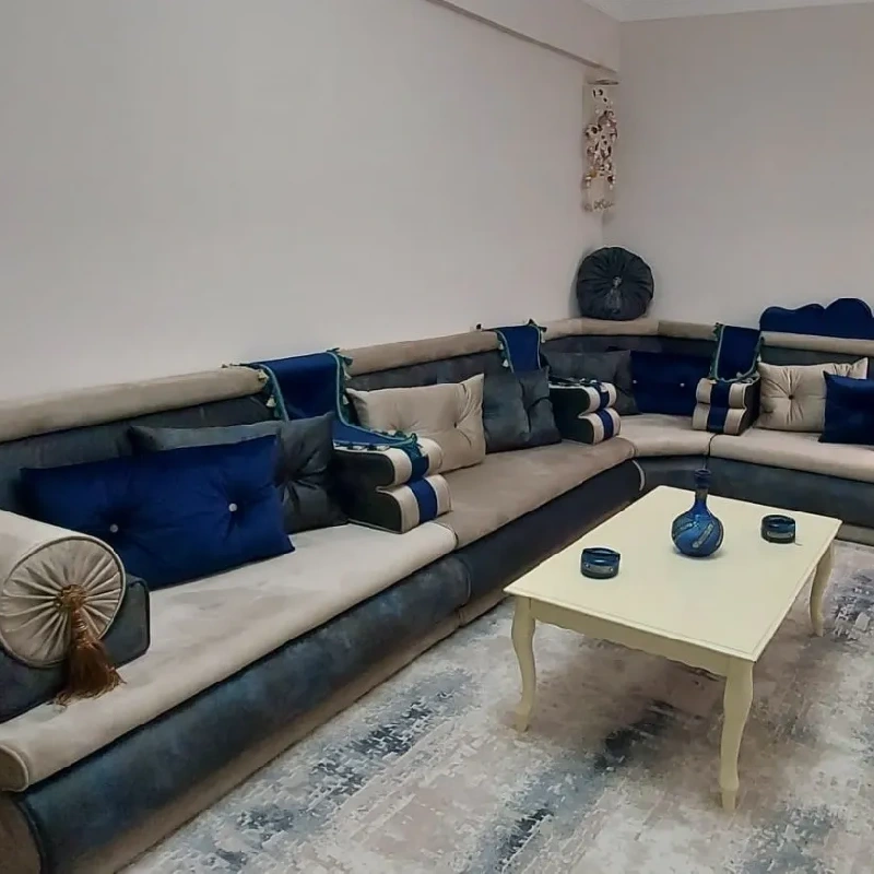 traditional Arabic ladies majlis with a large, low-slung, L-shaped sofa in shades of blue