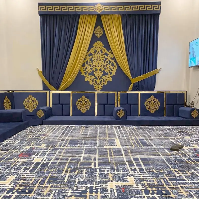 traditional Arabic majlis with a row of plush royal blue and gold floor cushions