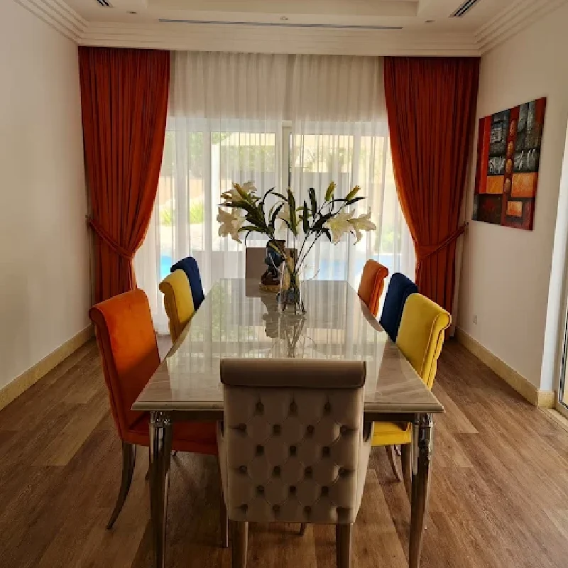 upholstery is a mix of solid-colored velvet and a tufted neutral fabric chairs