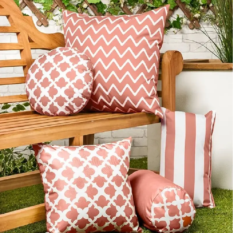 wooden bench is decorated with several outdoor cushions in various patterns