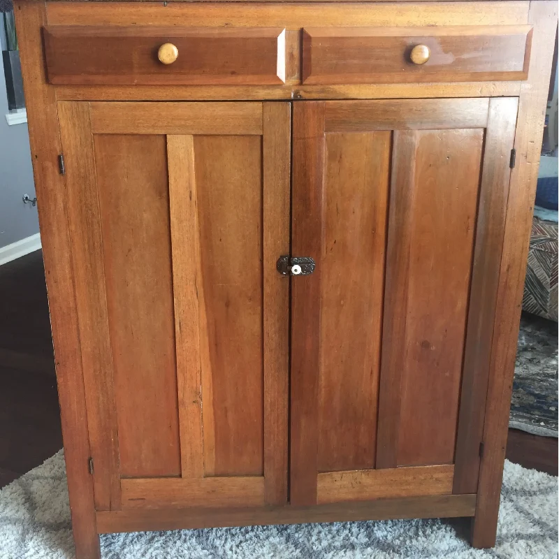 wooden cabinet with a dark metal latch