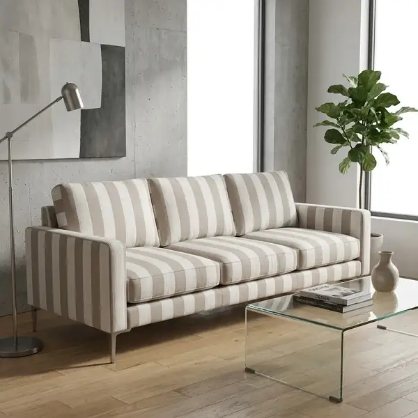 Beige striped fabric upholstered sofa in modern interior