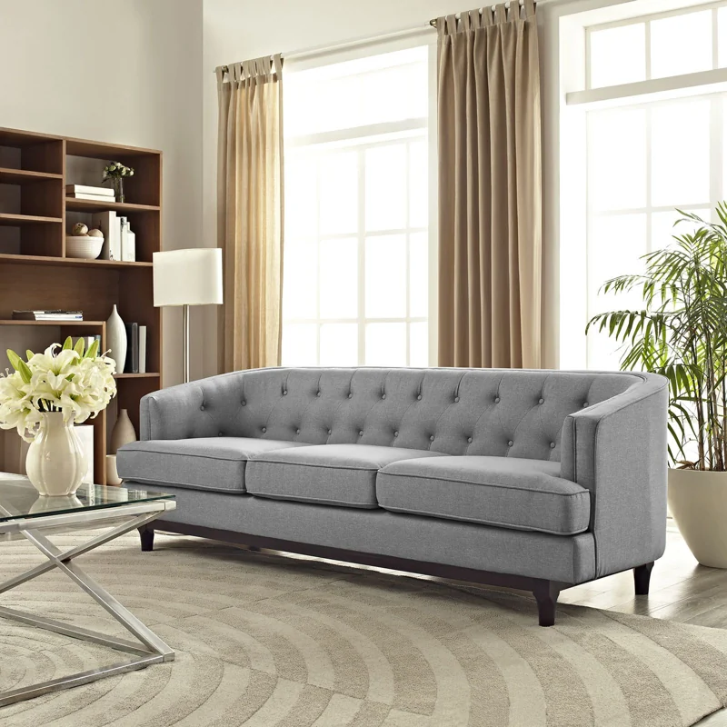 Beige textured fabric sofa upholstery with throw pillows
