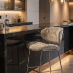 Beige velvet bar stool at a modern dark kitchen island