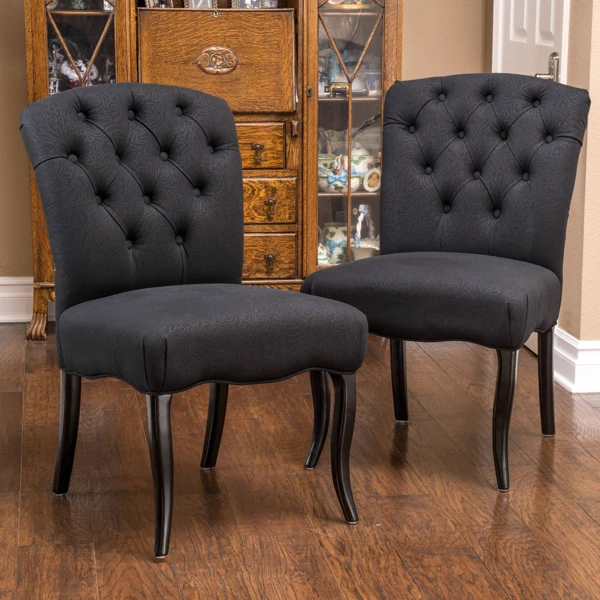 Black tufted upholstery fabric dining chairs in dining room