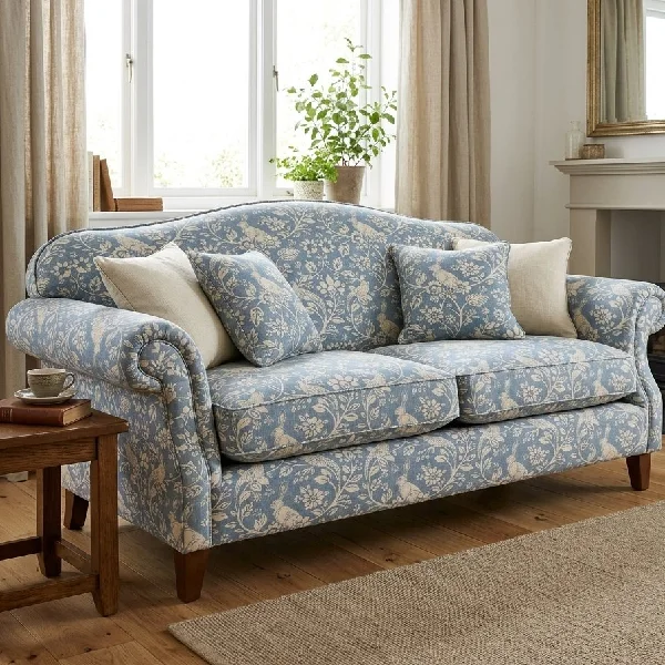 Blue floral sofa with matching throw pillows