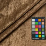 Bronze crushed velvet fabric swatch with a color card