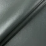 Close up macro texture shot of dark grey vinyl upholstery