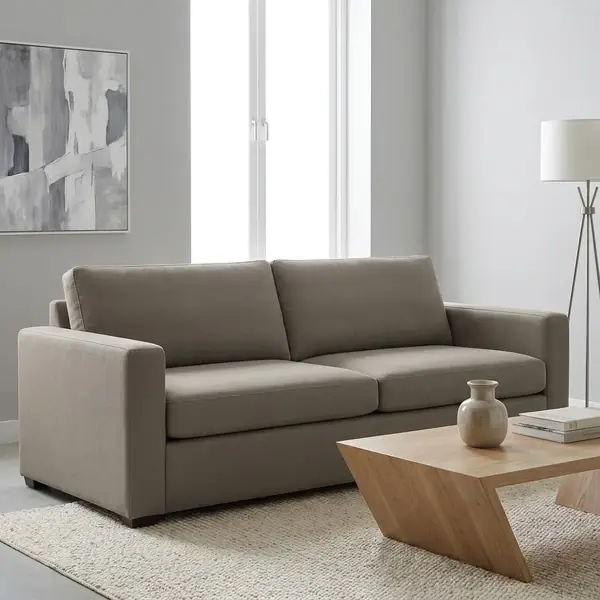 Modern taupe upholstered fabric sofa in living room setup