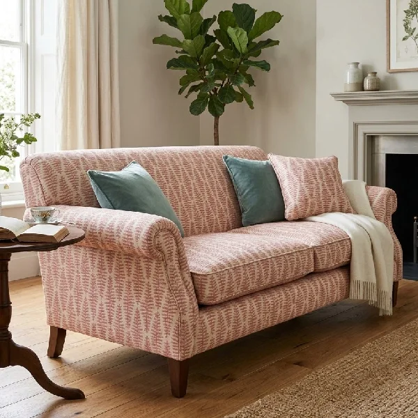 Pink fern pattern upholstered sofa with throw pillows