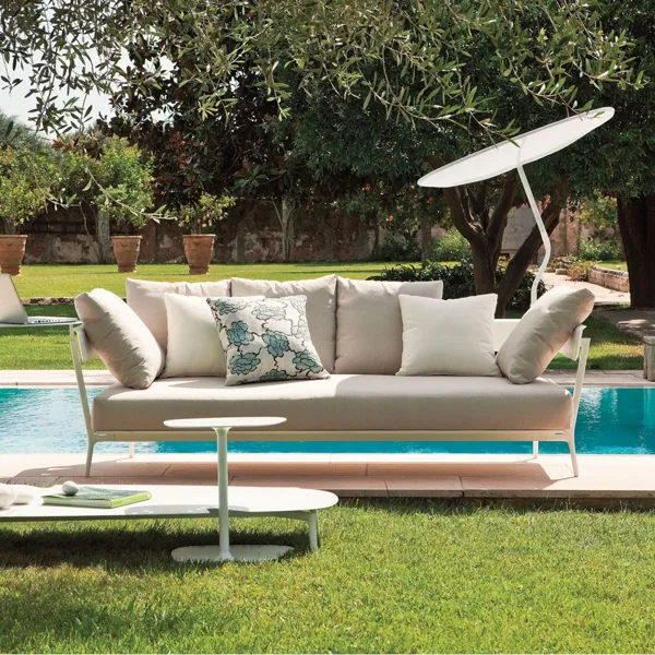Minimalist white outdoor daybed setup by poolside