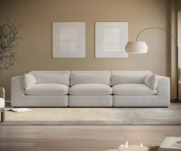 Beige curved bouclé sofa in modern neutral living room