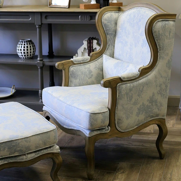Vintage blue toile fabric upholstery on wooden armchair